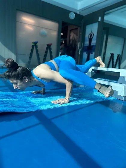 An arm balance variation using a step for support. This helps build the strength needed for the full pose.