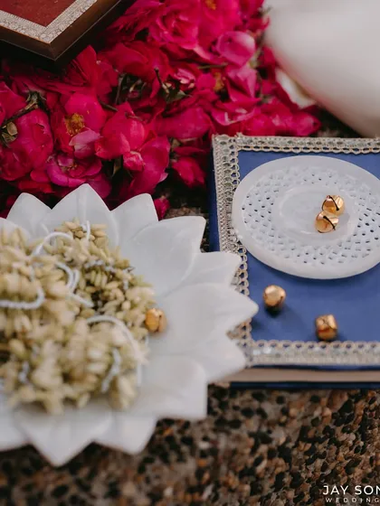 A close-up of traditional jasmine gajras and gold ghungroos, used as beautiful, fragrant, and symbolic decor elements.