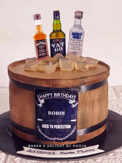 Aged to perfection! This non-fondant barrel cake is one of my most requested designs. It features a realistic wood texture made with whipped cream and is topped with miniature liquor bottles and edible ice cubes.