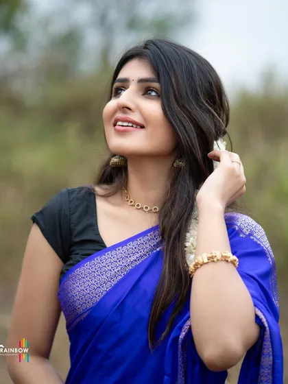 An upward glance towards the sky gives this portrait in a blue saree a hopeful and dreamy quality.