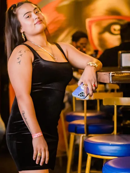 A guest posing in a black velvet dress.