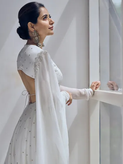 Elegance is in the details of this off-white chikankari georgette Anarkali. While it has a traditional feel, the daring open-back design adds a modern twist, making it a sophisticated choice for any celebration.