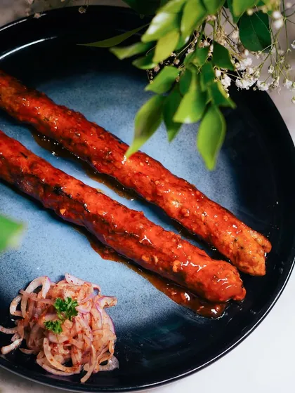 A beautifully plated serving of Chicken Lasooni Seekh. The vibrant color comes from fresh spices, and the dish is a testament to how I plate food to be as visually appealing as it is delicious.