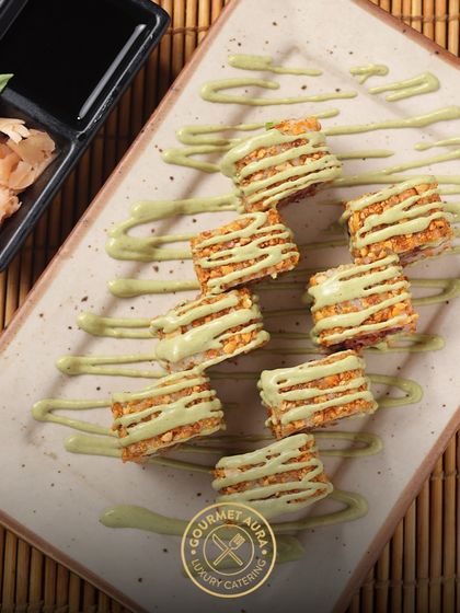 Crispy, crunchy sushi rolls drizzled with a wasabi-infused aioli. This dish offers a delightful textural contrast and a modern flavor profile.