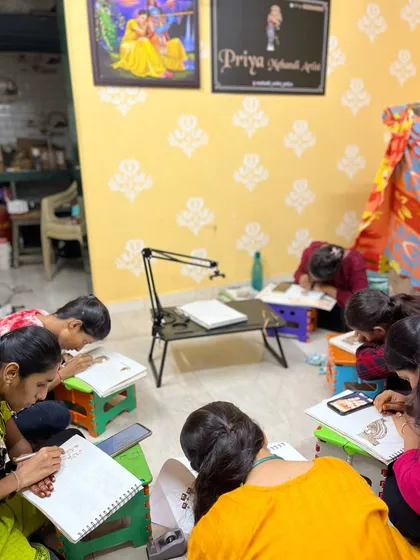 A snapshot of my class in session. You can see students working hard on their drawing pads, with a live demo setup in the center. I create a focused yet comfortable environment for everyone to learn at their own pace.