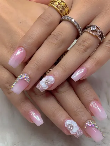 A shorter, stylish set with a pink and white ombre, 3D flowers, and rhinestone accents.