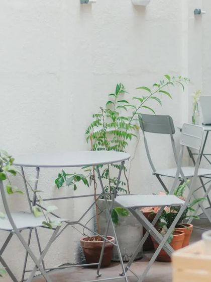 Our simple and elegant outdoor seating, surrounded by greenery. It is the perfect spot to work on your laptop or just enjoy the quiet.