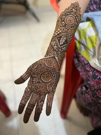 A heavy, intricate design covering the full hand and arm, perfect for an engagement.