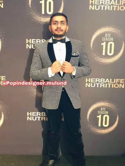 A client looking sharp in a black and white patterned tuxedo jacket. This is a great choice for a formal event where you want to stand out from the crowd.