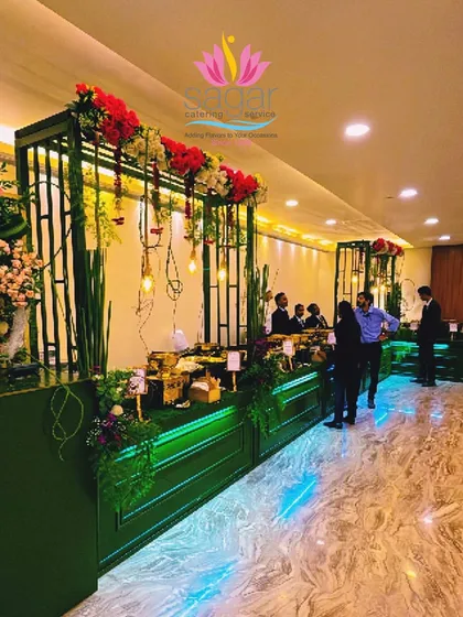 This is one of my signature Green and Gold themed buffet setups. I designed it to feel both grand and fresh, using lush florals, warm Edison bulb lighting, and elegant golden serving dishes to create a luxurious dining atmosphere for the wedding guests.