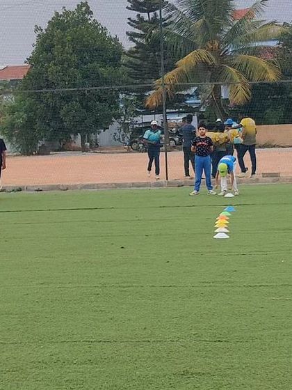 A wide view of a fielding session during our summer camp. We accommodate large groups while ensuring every player is engaged.