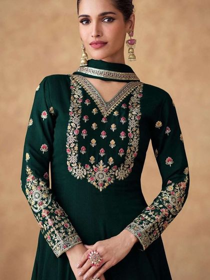 A dark green Anarkali gown that exudes grace. I designed this with heavy thread and sequin work on the neckline and sleeves, using Chinon silk for a beautiful drape.