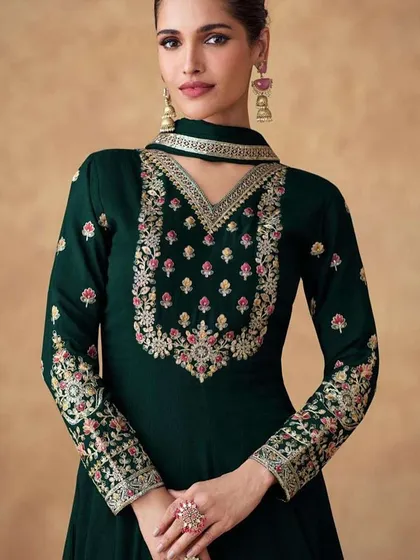 A dark green Anarkali gown that exudes grace. I designed this with heavy thread and sequin work on the neckline and sleeves, using Chinon silk for a beautiful drape.