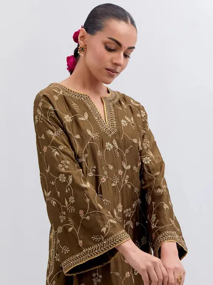 A detailed shot of the olive green kurta, focusing on the intricate gold embroidery around the v-neckline and the delicate floral patterns on the sleeves.