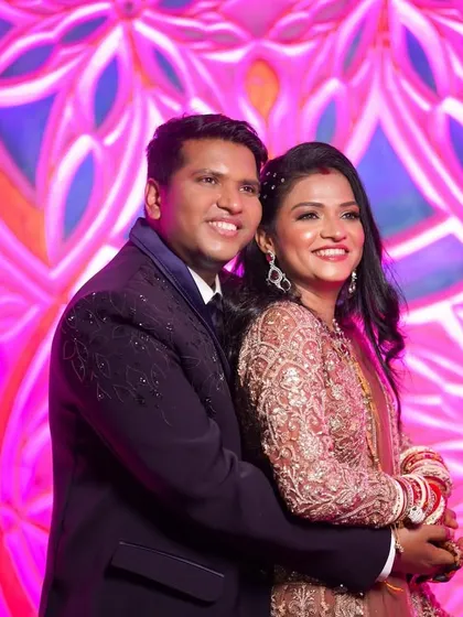 A happy portrait of the couple at their reception. The bride's makeup is radiant and joyful, matching the energy of the event.
