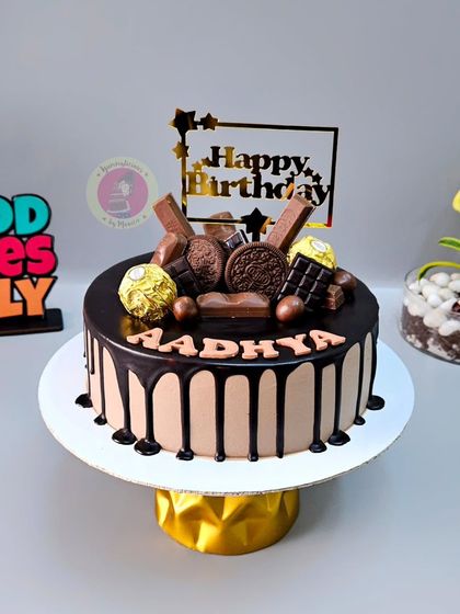 A classic chocolate drip cake, overloaded with Ferrero Rocher, KitKat, and Oreo cookies.