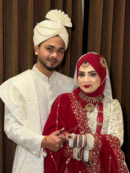 A close-up of my beautiful Hijabi bride. The details of her makeup, from the perfectly blended eyeshadow to the crisp red lip, are clearly visible.