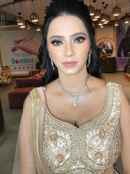 An elegant and classic look for a wedding guest, featuring defined eyes, a soft pink lip, and a traditional hairstyle.