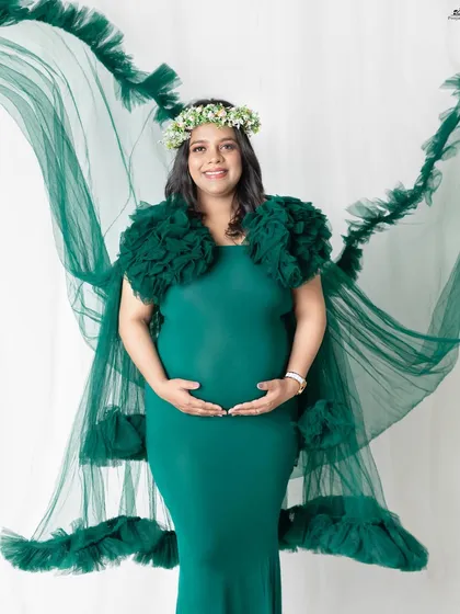 The emerald green gown with its long, flowing tulle cape is a client favorite. It creates a beautiful, ethereal effect that looks incredible in photos, especially when we add a little air from a fan.