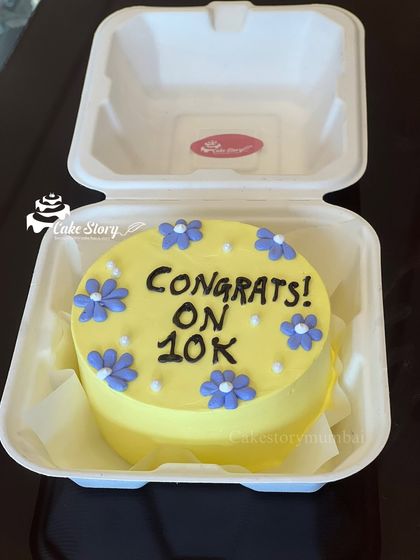 Simple, sweet, and celebratory. This yellow bento cake with purple flowers was made to say "Congrats! on 10k," marking a special milestone.