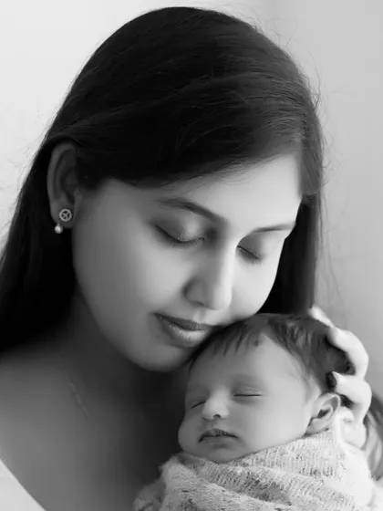 A serene black and white close-up of a mother and her newborn. This intimate portrait beautifully captures the quiet, loving bond between them.