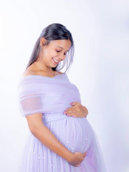A serene solo portrait in our lavender Breezy gown. The off-shoulder design and delicate pearl details create a soft and romantic look.