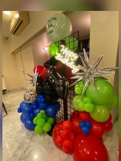 Another angle of the gaming theme decor, showing how the neon sign and controller foil balloon are integrated into the dynamic balloon arrangement.