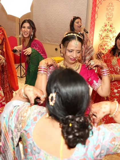 Watching the ladies of the family perform a traditional dance. It's a beautiful display of culture, and I make sure to give it the spotlight it deserves.