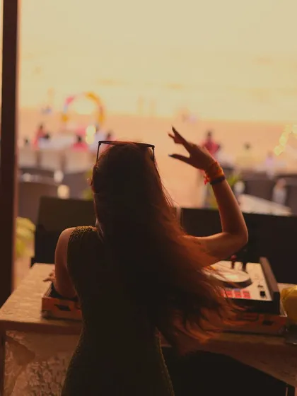 Lost in the music as the sun goes down. My silhouette against the golden sky, with my hair catching the ocean wind.