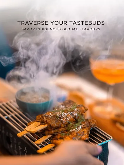 We ignite your senses with dishes that are a spectacle of flavor and aroma. This dramatic shot of steaming grilled satay on a traditional tabletop grill embodies our passion for creating indigenous global flavors that offer a truly immersive dining experience.