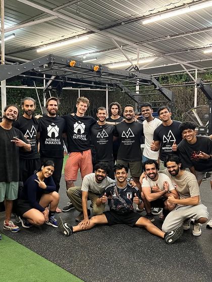 The full coaching team and adult students pose after a workshop with ADAPT Qualifications, showing the strong community spirit.