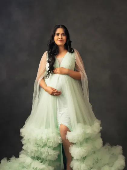 A vision in mint green. This beautiful ruffled tulle gown offers a fresh and elegant look for your special occasion.
