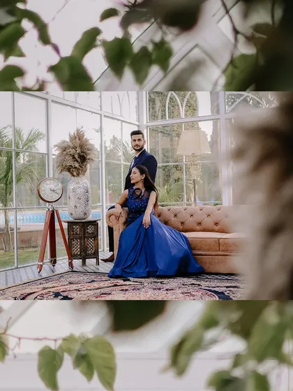 An indoor portrait with a creative touch. The leaves in the foreground frame the couple, making the viewer feel like they are peeking in on an intimate moment.