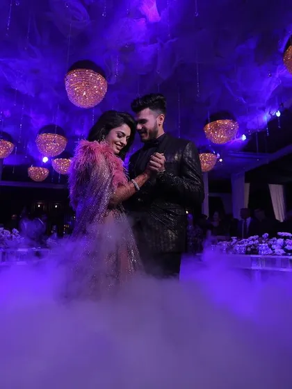 The first dance is a magical moment. I use theatrical elements like low-lying fog and dramatic purple uplighting to create a dreamy, cloud-like effect for the couple's special performance.
