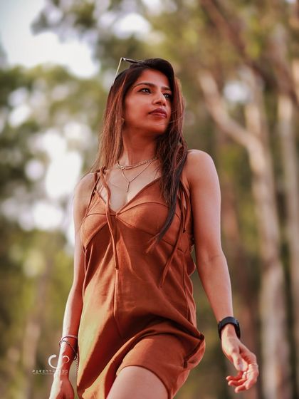 A low-angle shot that makes the subject look powerful and statuesque. The golden light and natural background create a beautiful, earthy palette.