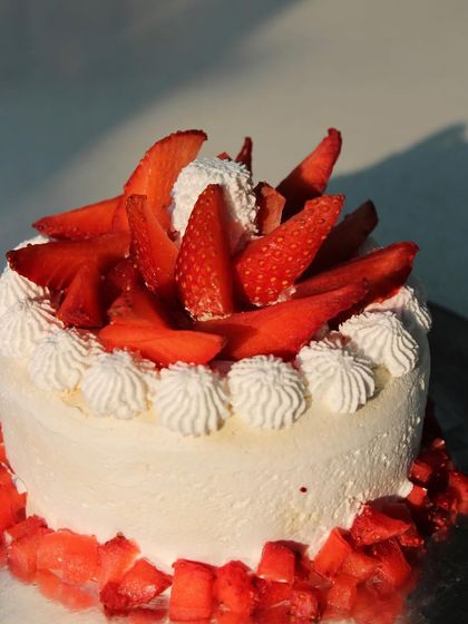 Our fresh strawberry cake is a light and delightful treat. It's topped with fresh strawberries and a creamy vegan frosting, making it a perfect celebration cake.