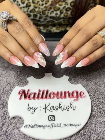 A lovely French ombre set on stiletto nails, with delicate 3D flowers and glitter accents.