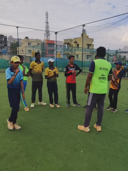 A coach leading a team discussion on the field. We encourage players to think about the game and understand strategy.