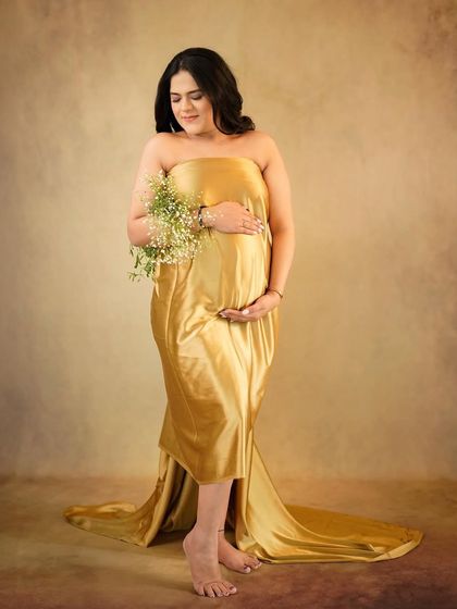 A classic portrait with a golden satin drape, exuding warmth and timeless elegance.