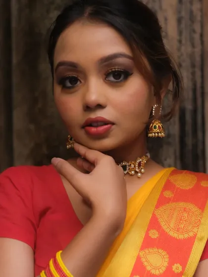 A portrait showcasing a classic makeup look with a defined brown smokey eye and neutral lip color. This versatile style works beautifully for many different traditional events and outfits.