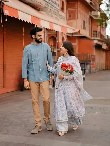 A candid photograph of the couple walking and chatting, capturing their natural chemistry and the authentic vibe of the city.