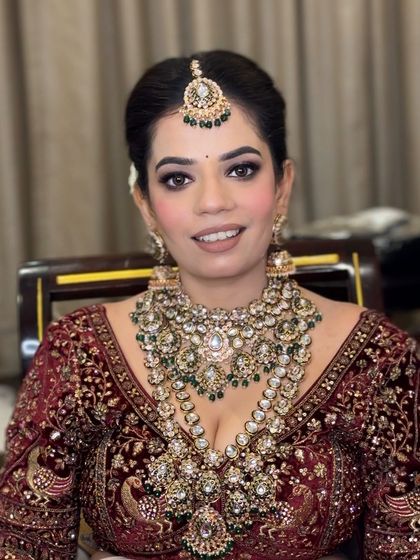 A close-up of Ashima's airbrush bridal makeup. The eyes are defined with a soft smokey look, and the skin is absolutely glowing.