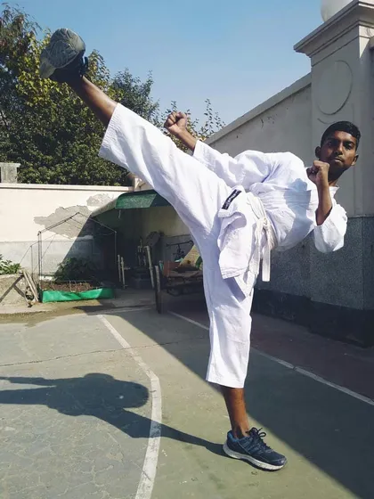 A young student executes a clean side kick with excellent form and focus. Mastering the basics is the first step toward becoming a great martial artist.