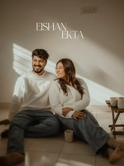 The beautiful morning light streaming through the blinds creates a lovely, warm atmosphere for this at-home couple portrait. It's simple, serene, and all about their connection.