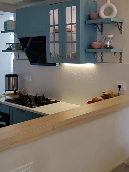 Different shots from our Lotus Boulevard project, where we opened up the kitchen to the dining area. The French-style blue kitchen, dining nook, and colorful decor create a vibrant and interactive living space.