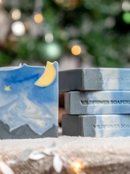 A stack of soap bars designed to look like a starry night sky. This showcases the artistic and creative side of the soap maker's craft.
