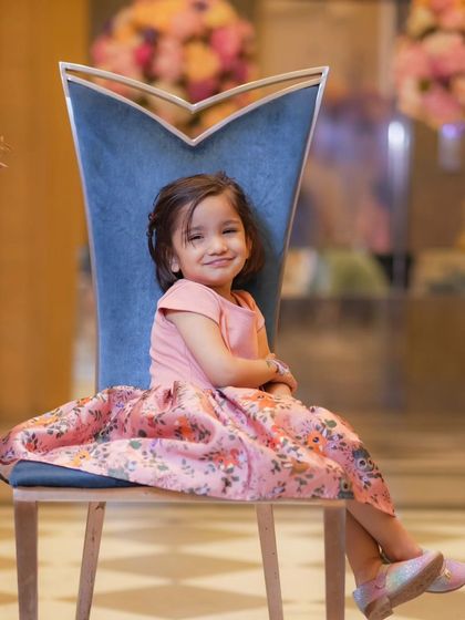 A portrait of a young girl looking poised and sweet in a beautiful floral dress. I use simple, elegant settings to let your child's personality be the main focus.