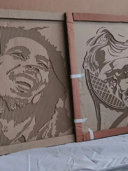 Got junk? We'll make art out of it. Here are two of our signature upcycled cardboard portraits of legends Bob Marley and Roger Federer, created entirely from discarded carton boxes.