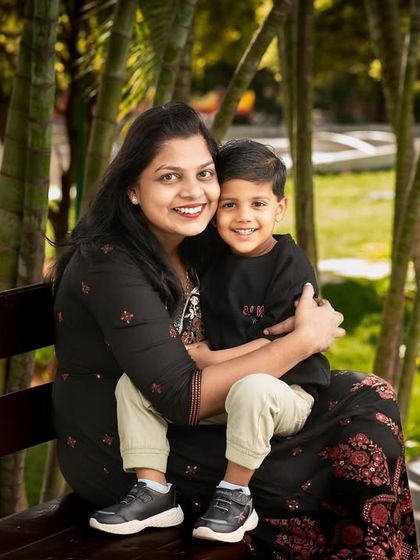 A classic mother and son portrait on a park bench. Their happy smiles and the beautiful natural light make for a perfect, timeless photograph.