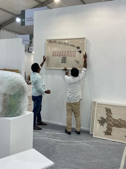 The team hanging works by Archana Hande, ensuring perfect placement.